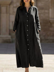 Black FJØRNA solid color cotton linen button maxi dress with a flowing silhouette and long sleeves.