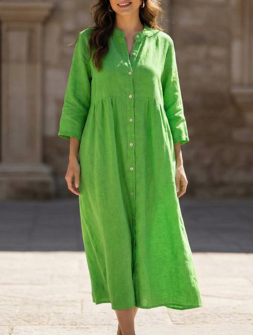 White cotton linen maxi dress with buttons from FJØRNA, featuring a solid color and flowing silhouette.