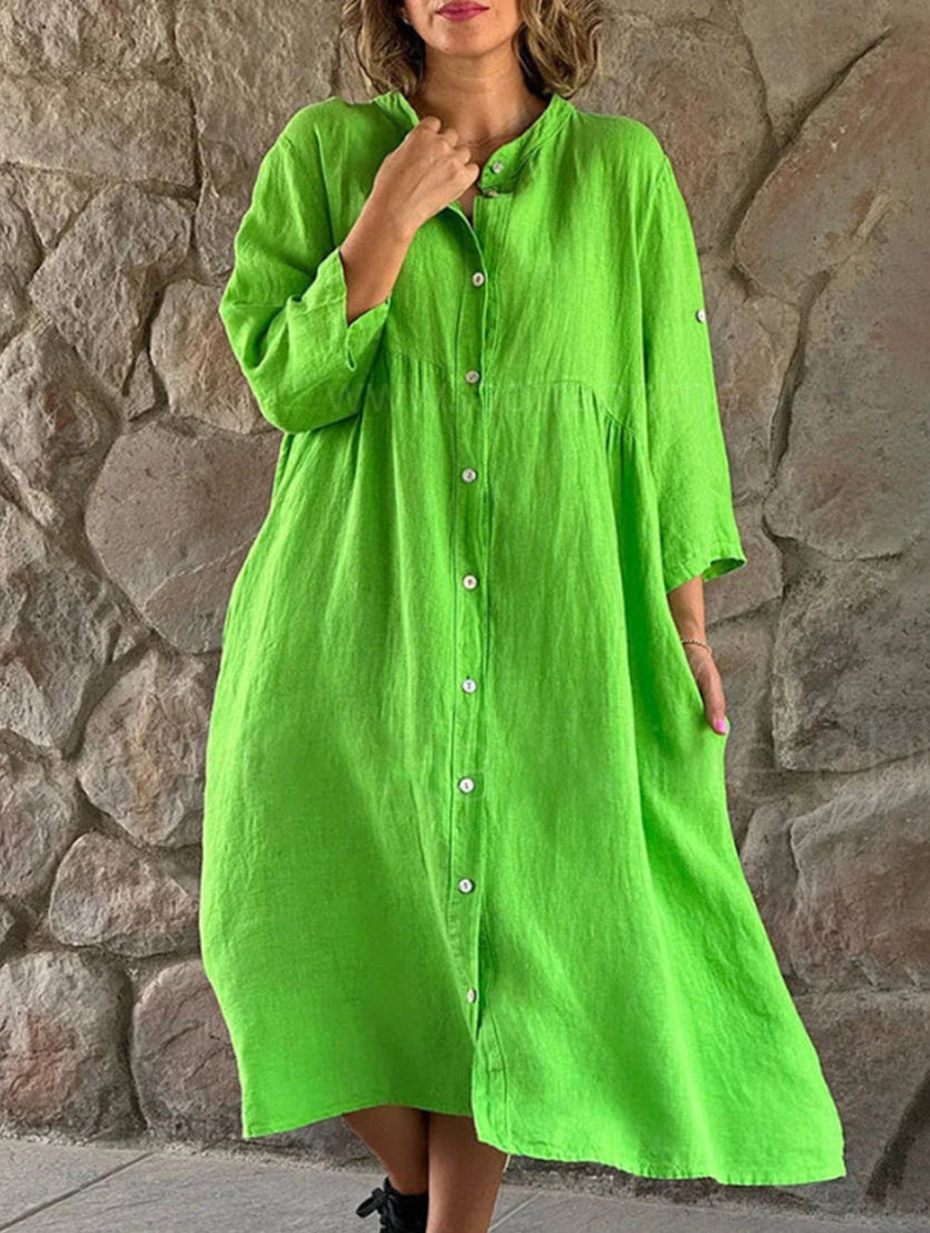 White cotton linen maxi dress by FJØRNA featuring solid color, button details, and a flowing, elegant silhouette.