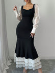 Black colorblock long sleeve mermaid dress by FJØRNA featuring fitted silhouette and elegant design.