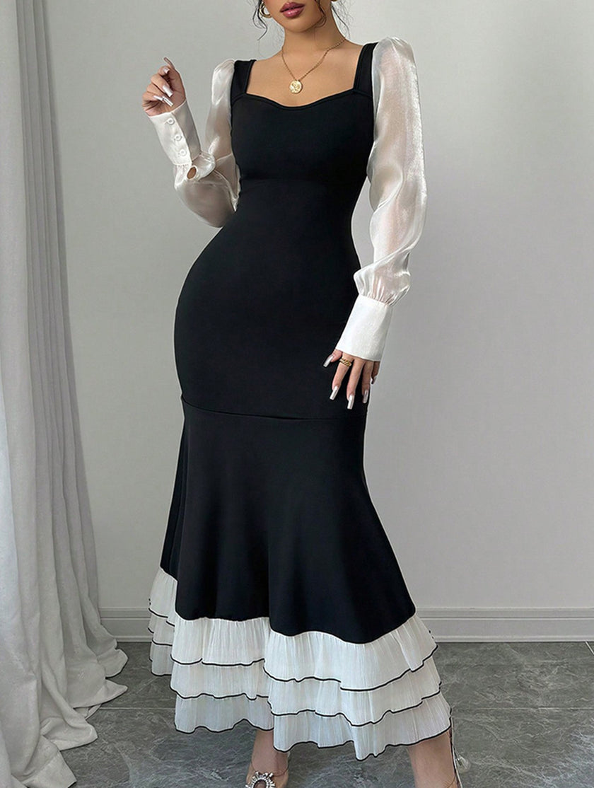 Black colorblock long sleeve mermaid dress by FJØRNA featuring fitted silhouette and elegant design.