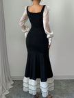 Black colorblock long sleeve mermaid dress by FJØRNA featuring fitted silhouette and elegant design.
