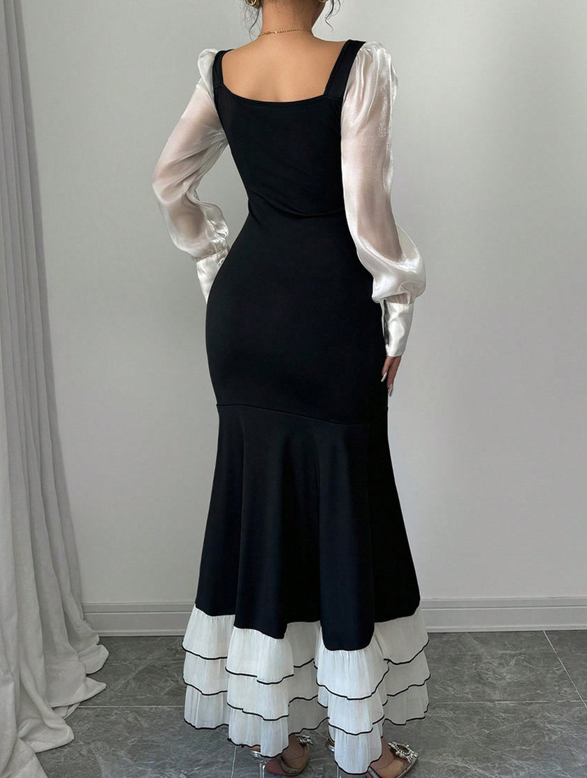 Black colorblock long sleeve mermaid dress by FJØRNA featuring fitted silhouette and elegant design.