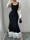 FJØRNA colorblock long sleeve mermaid dress in black and white, fitted silhouette with elegant design and stylish color blocking.