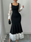 FJØRNA colorblock long sleeve mermaid dress in black and white, fitted style with elegant design and seamless fabric.
