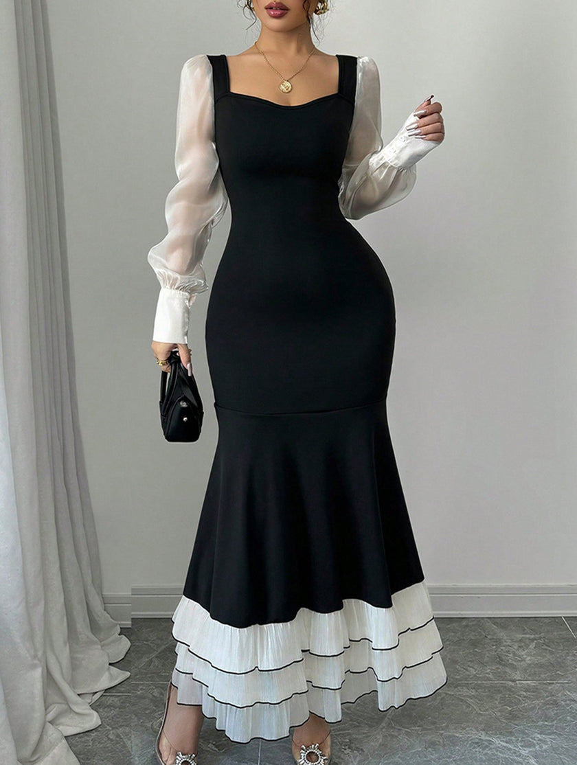 FJØRNA colorblock long sleeve mermaid dress in black and white, fitted style with elegant design and seamless fabric.
