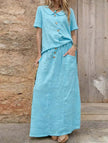 FJØRNA casual solid blue loose women's dress, suitable for weddings, featuring a relaxed fit and simple elegant style.