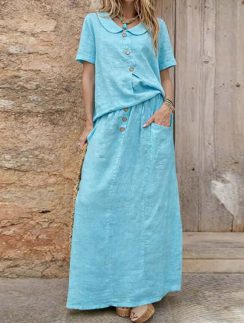 FJØRNA casual solid blue loose women's dress, suitable for weddings, featuring a relaxed fit and simple elegant style.