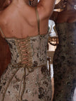 White FJØRNA backless maxi dress with a low neckline and elegant tie detail, perfect for formal occasions.