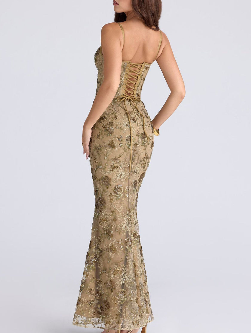 White FJØRNA backless maxi dress with a low neckline and elegant tie detail, flowing and stylish for formal occasions.