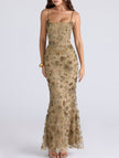 White FJØRNA maxi dress with a low backless design and tie detail, elegant and flowing for formal occasions.