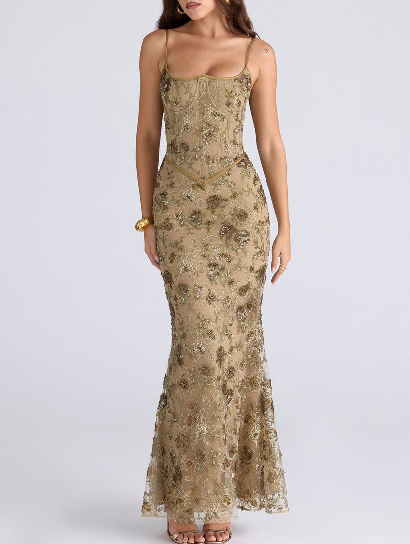 White FJØRNA maxi dress with a low backless design and tie detail, elegant and flowing for formal occasions.