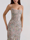 Backless white maxi dress with a low neckline and elegant tie detail by FJØRNA, perfect for formal occasions.