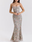 Backless white maxi dress by FJØRNA with a low neckline and elegant tie detail, perfect for formal occasions.