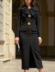 Black FJØRNA V-neck bow waist-cinching dress with elegant design and fitted silhouette, showcasing the stylish dress front view.