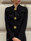 Black FJØRNA V-neck bow waist-cinching dress with elegant design, featuring a flattering fit and stylish details.