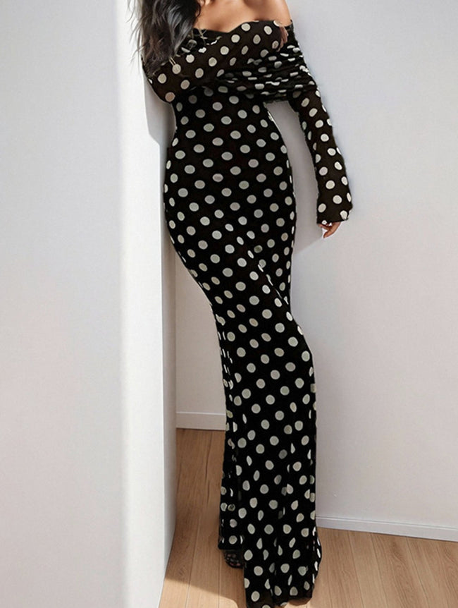 Black polka dot and elegant white dress by FJØRNA, featuring a stylish design and flowing fabric for sophisticated wear.