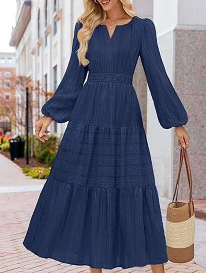 White V neck tiered puff sleeve maxi dress by FJØRNA, flowing design with layered fabric and elegant silhouette.