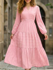 FJØRNA white V-neck tiered puff sleeve maxi dress displayed on a hanger, showcasing its flowing fabric and elegant design.