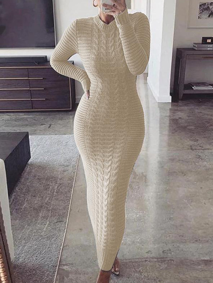 FJØRNA beige cable knit long-sleeved wool dress, stylish and cozy, shown on a model with a fitted silhouette.
