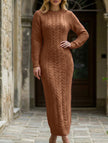 White FJØRNA cable knit long-sleeved wool dress displayed on a hanger, showcasing its cozy, textured knit design.