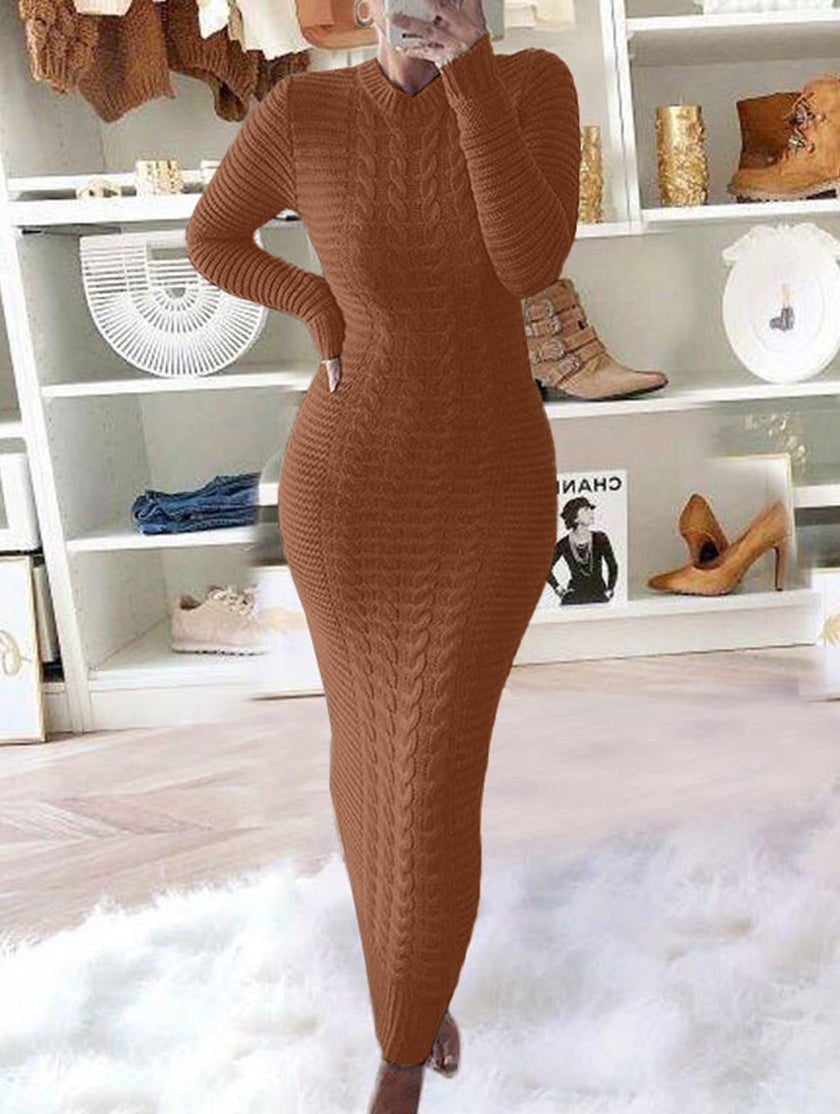 White FJØRNA cable knit long-sleeved wool dress displayed on a hanger against a neutral background.