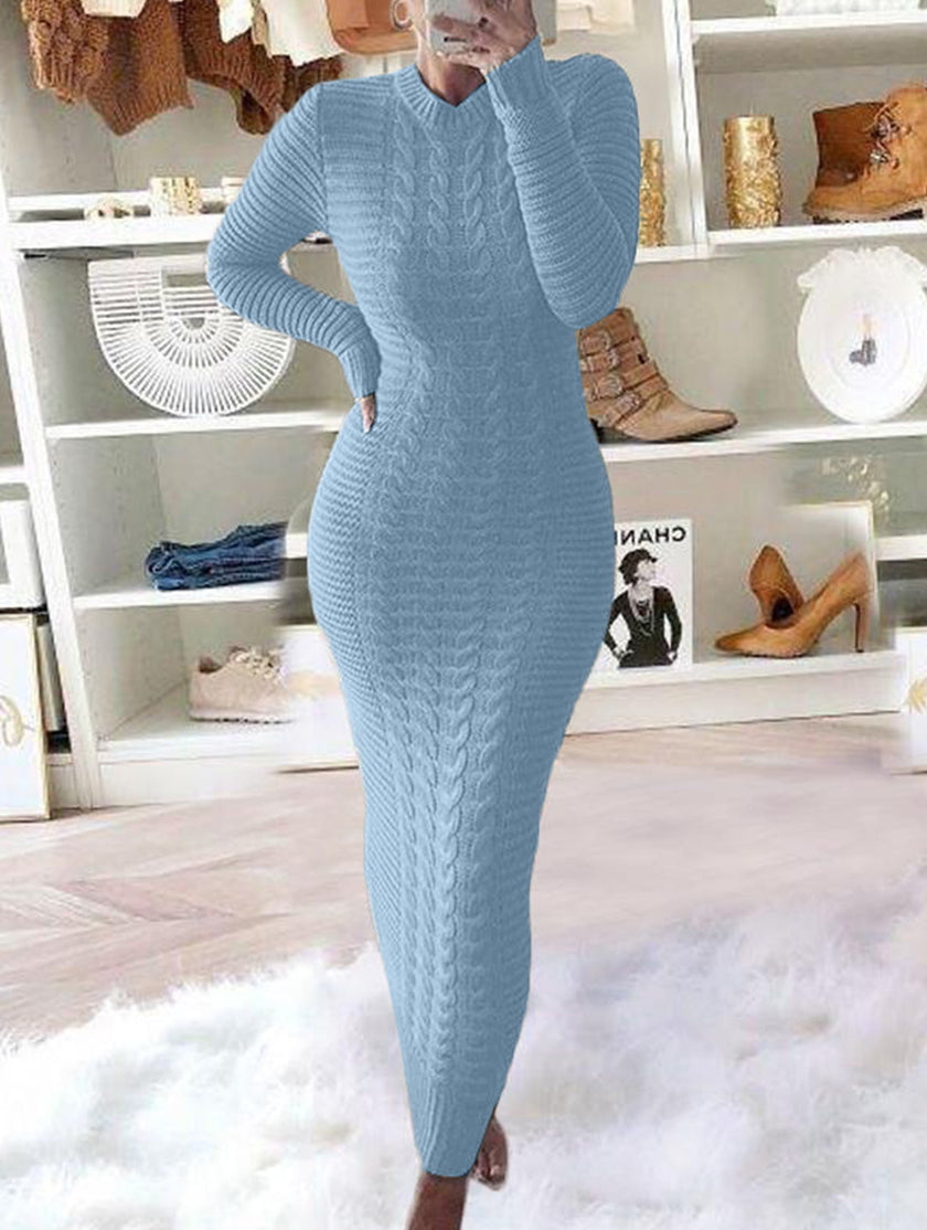 White cable knit wool long-sleeved dress by FJØRNA, shown on a model, featuring a cozy, fashionable design perfect for winter wear.