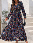 Women's printed V-neck full skirt dress by FJØRNA, featuring a stylish design and flowing silhouette in black fabric.