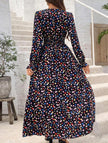Women's printed V-neck full skirt dress by FJØRNA, featuring a stylish design and flowing silhouette in black.