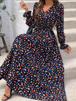 Women's printed V-neck full skirt dress by FJØRNA with a stylish black and white design, perfect for casual or semi-formal occasions.