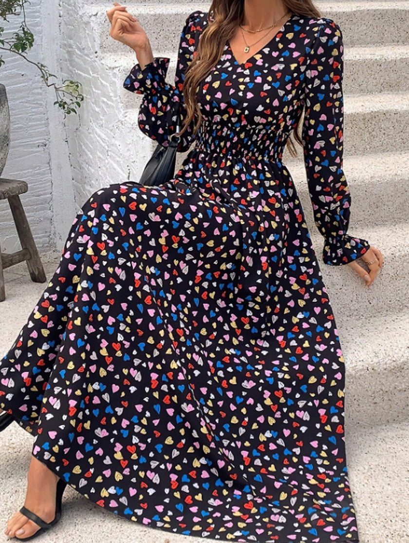 Women's printed V-neck full skirt dress by FJØRNA with a stylish black and white design, perfect for casual or semi-formal occasions.