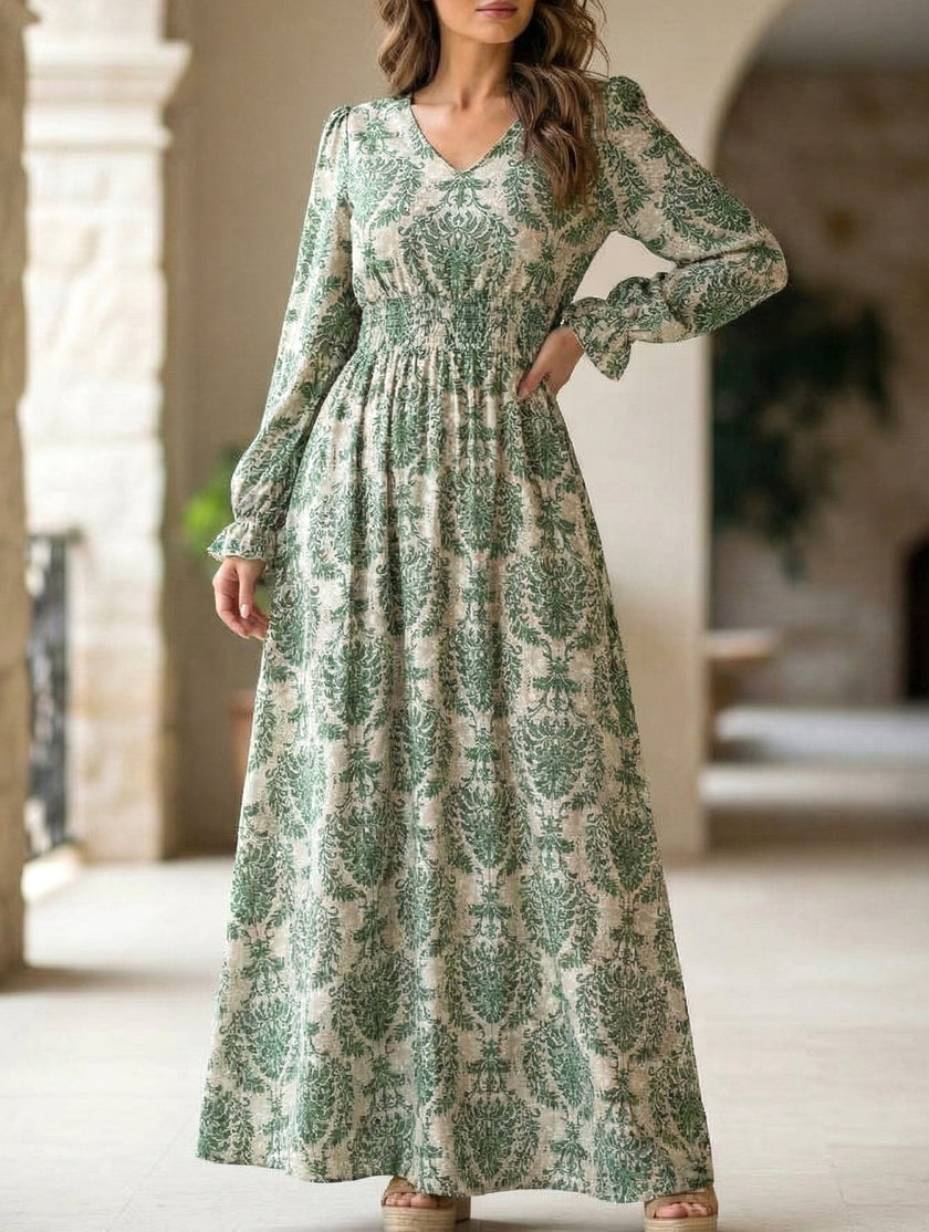 FJØRNA women's printed V-neck full skirt dress in white, featuring a colorful floral pattern and flowing silhouette.