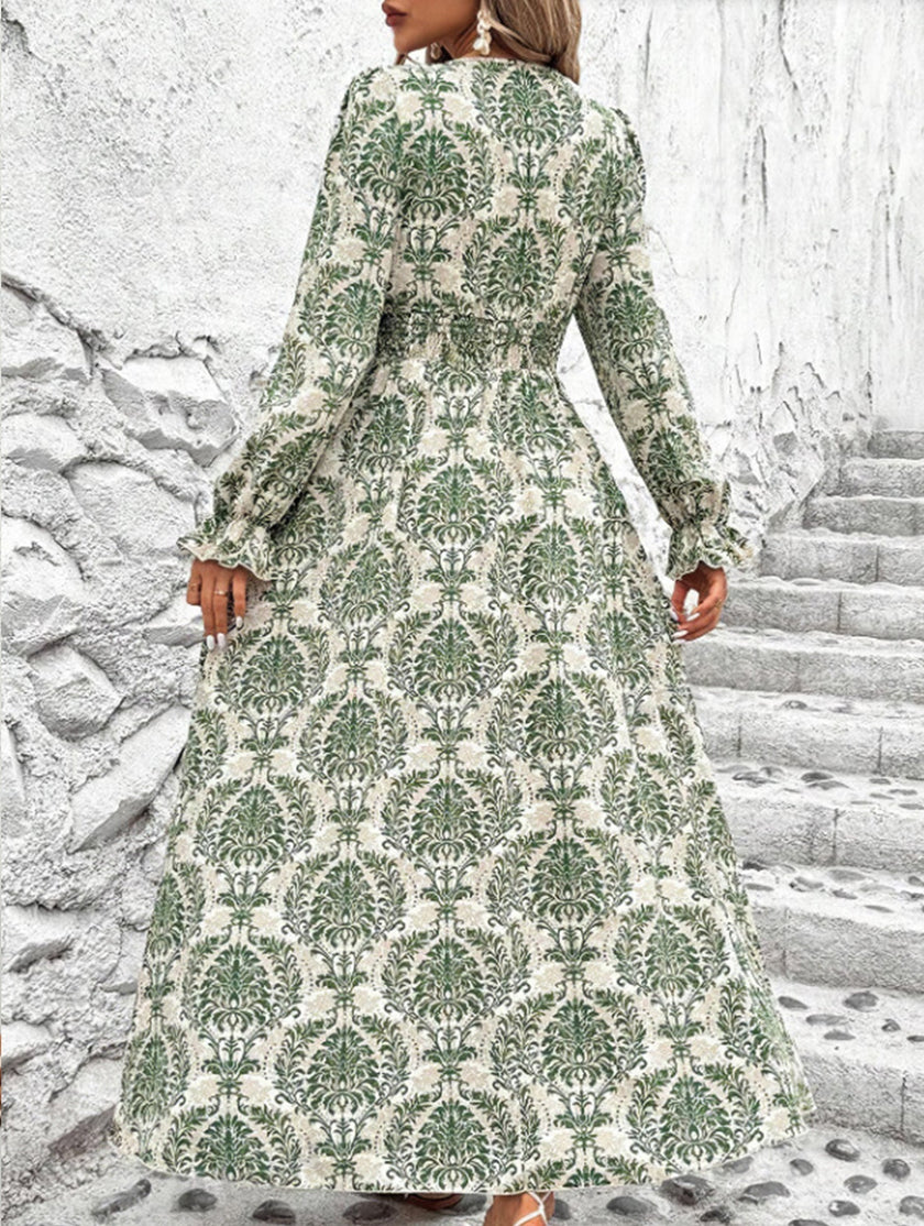 Women's printed V-neck full skirt dress by FJØRNA, featuring a stylish white design and flowing fabric.