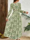 FJØRNA vintage print white V-neck long sleeve maxi dress with floral pattern, flowing fabric, and elegant design.