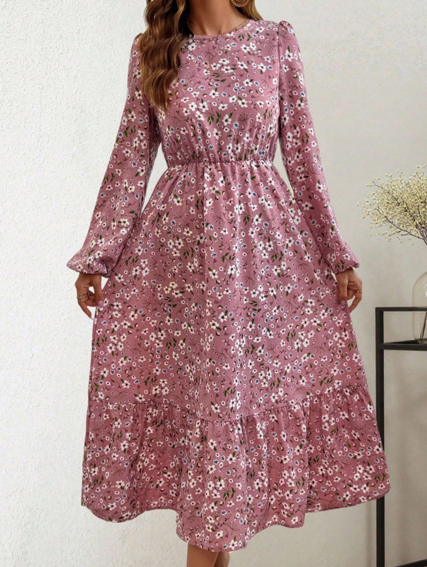 White floral high waist long sleeve midi dress by FJØRNA, showcasing elegant design and flowy fabric in a stylish pose.