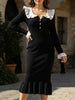Black FJØRNA ruffle V-neck slim long sleeve dress, showcasing delicate ruffle details and fitted silhouette.