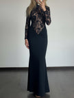 Black lace hollow mock neck bodycon dress by FJØRNA shown on a model, featuring intricate lace details and a fitted silhouette.