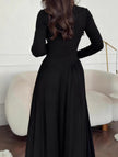 Black solid U-neck fit and flare dress by FJØRNA, shown on a hanger with detailed neckline and flared skirt.