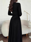 Black solid U-neck fit and flare dress by FJØRNA featuring a stylish silhouette and elegant design.