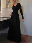 Black solid U-neck fit and flare dress by FJØRNA, showing the stylish silhouette and elegant design on a model.