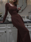 White solid U-neck fit and flare dress by FJØRNA, shown in image with elegant design and knee-length silhouette.