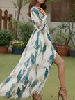 White backless V-neck slit dress by FJØRNA, featuring a flowing design and elegant style for special occasions.