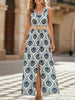 FJØRNA floral print sleeveless dress with slit, white dress featuring blue floral pattern, perfect for summer or casual occasions.