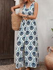 Blue floral print sleeveless dress by FJØRNA with slit design, showcasing a stylish and elegant summer dress.