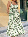 FJØRNA white maxi dress with leaf print cami waist design, flowy and elegant for summer or casual wear.
