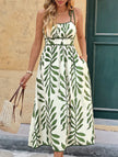 FJØRNA leaf print white maxi dress with cami waist, flowing design, featuring green foliage pattern and lightweight fabric.
