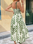FJØRNA leaf print white maxi dress with cami waist and flowing design, featuring green leaf patterns on lightweight fabric.
