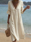 White linen V-neck loose maxi dress by FJØRNA, flowing and lightweight, perfect for casual or summer wear.