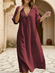 White linen V-neck loose maxi dress by FJØRNA, flowing and elegant with a relaxed fit for casual or summer wear.