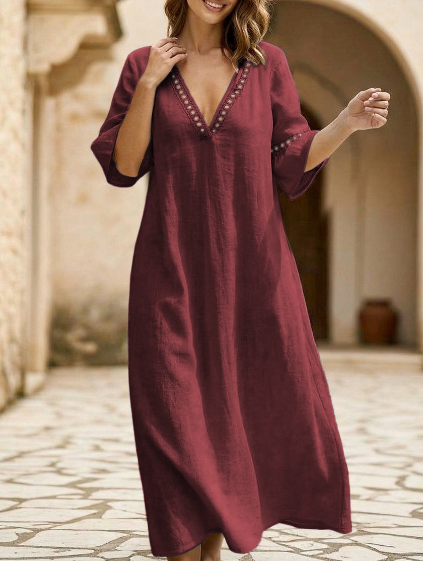 White linen V-neck loose maxi dress by FJØRNA, flowing and elegant with a relaxed fit for casual or summer wear.